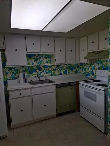 a kitchen with stainless steel appliances a stove and cabinets