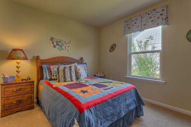 1009 Limpkin Street Crestview, FL 32539 - Photo 14 of 21 a bedroom with a bed and a window