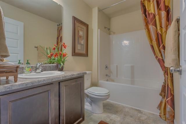 1009 Limpkin Street Crestview, FL 32539 - Photo 15 of 21 a bathroom with a granite countertop sink toilet and shower