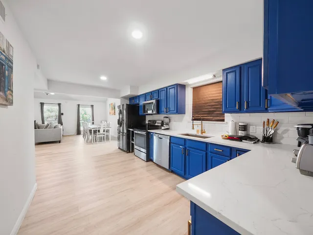 a large kitchen with stainless steel appliances and a sink