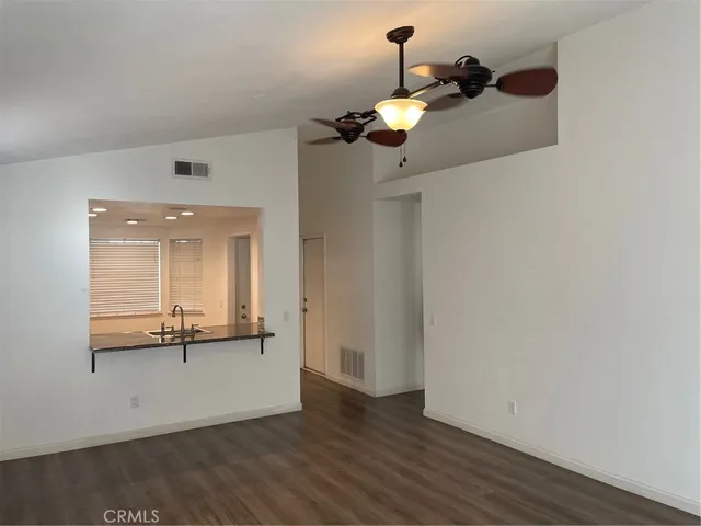 a view of a room with wooden floor and cabinet