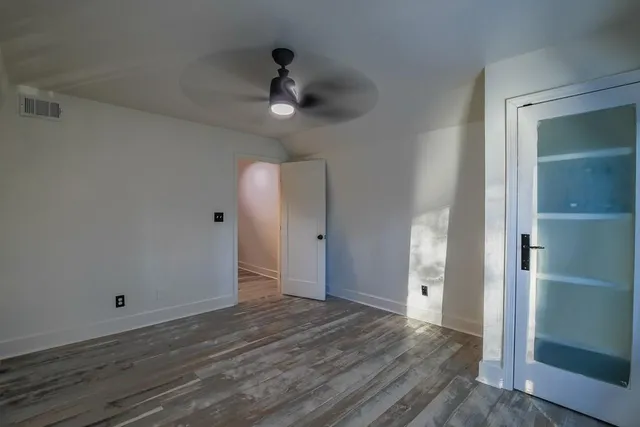 a view of an empty room and wooden floor