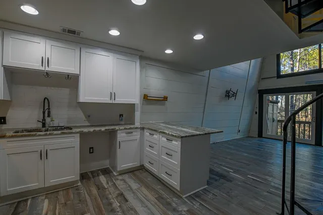 a kitchen with stainless steel appliances granite countertop a sink a stove and a refrigerator