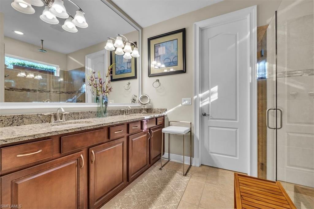 16424 Windsor Way Alva, FL 33920 - Photo 20 of 48 a spacious bathroom with a granite countertop sink a mirror and a shower