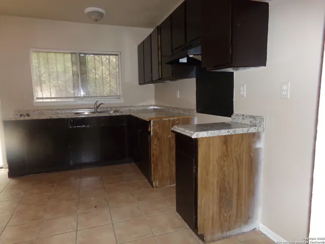 a kitchen with a sink and a refrigerator