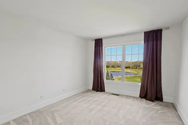 a view of an empty room and a window