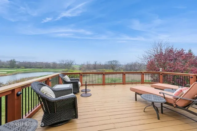 a balcony with wooden floor and outdoor seating