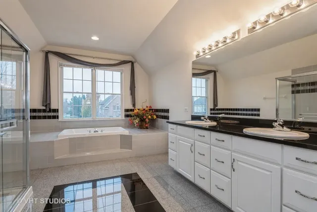 a large bathroom with a large tub and sink