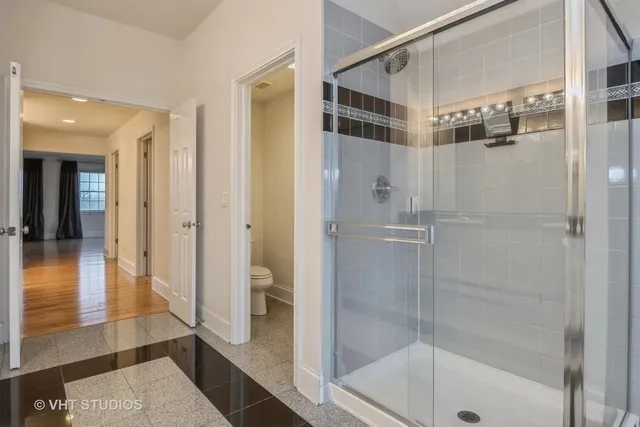 a bathroom with a shower and a glass door