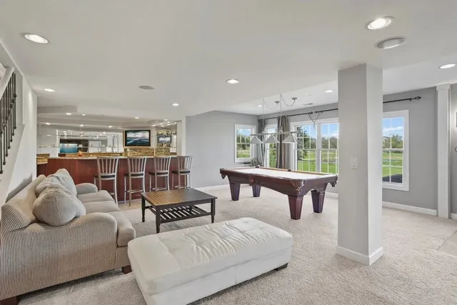 a bedroom with furniture and a large window