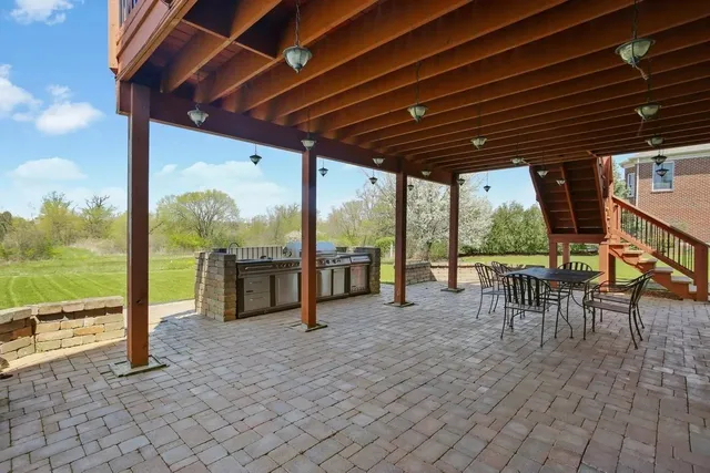 a view of a porch with furniture and backyard