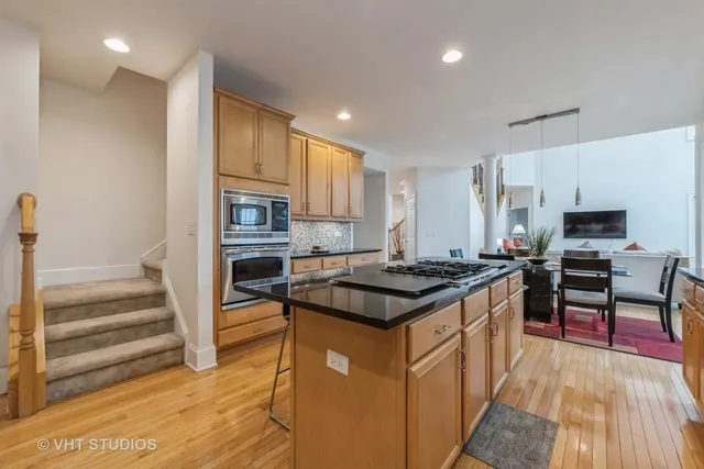 a kitchen with stainless steel appliances granite countertop a stove and a refrigerator