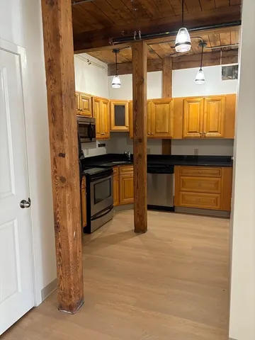 a kitchen with stainless steel appliances granite countertop a stove and a refrigerator
