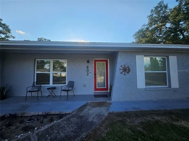 a view of a porch with furniture and next to window