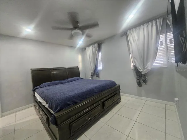 a bedroom with a bed and a mirror