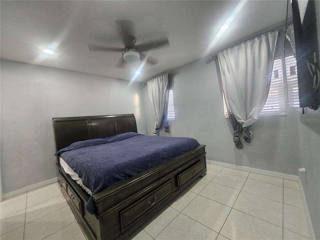 802 Windsor Circle Brandon, FL 33510 - Photo 13 of 17 a bedroom with a bed and a mirror