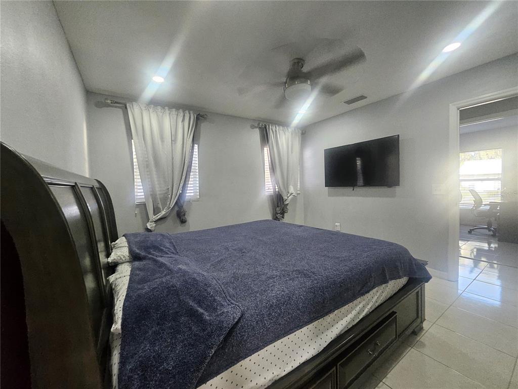 802 Windsor Circle Brandon, FL 33510 - Photo 14 of 17 a bedroom with a bed window and a television