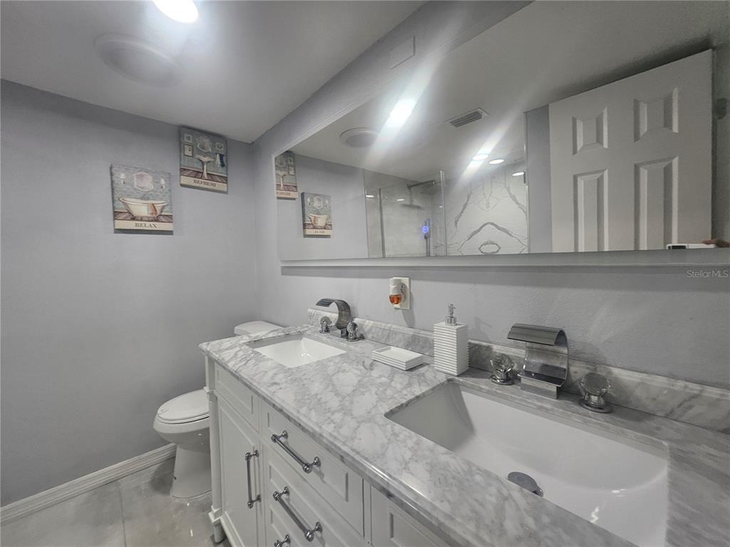 802 Windsor Circle Brandon, FL 33510 - Photo 17 of 17 a bathroom with a granite countertop sink a toilet and a mirror