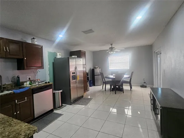 a kitchen with a cabinets and chairs