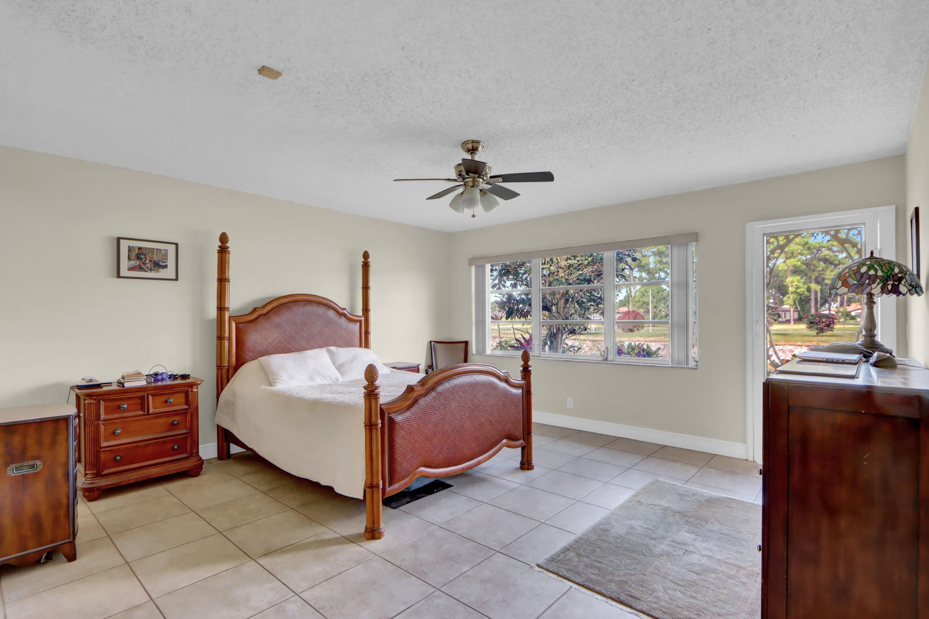 14050 Nesting Way, Unit B Delray Beach, FL 33484 - Photo 12 of 18 a spacious bedroom with a bed and window