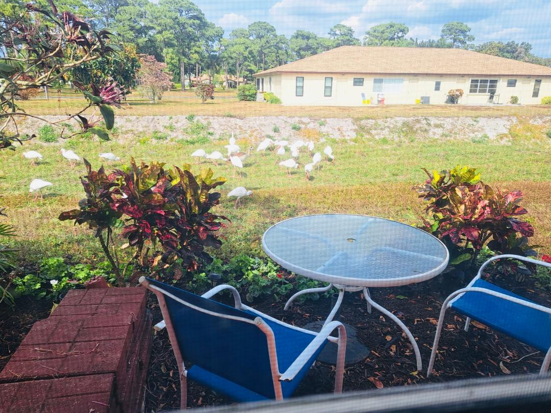 14050 Nesting Way, Unit B Delray Beach, FL 33484 - Photo 17 of 18 a view of a swimming pool with a patio