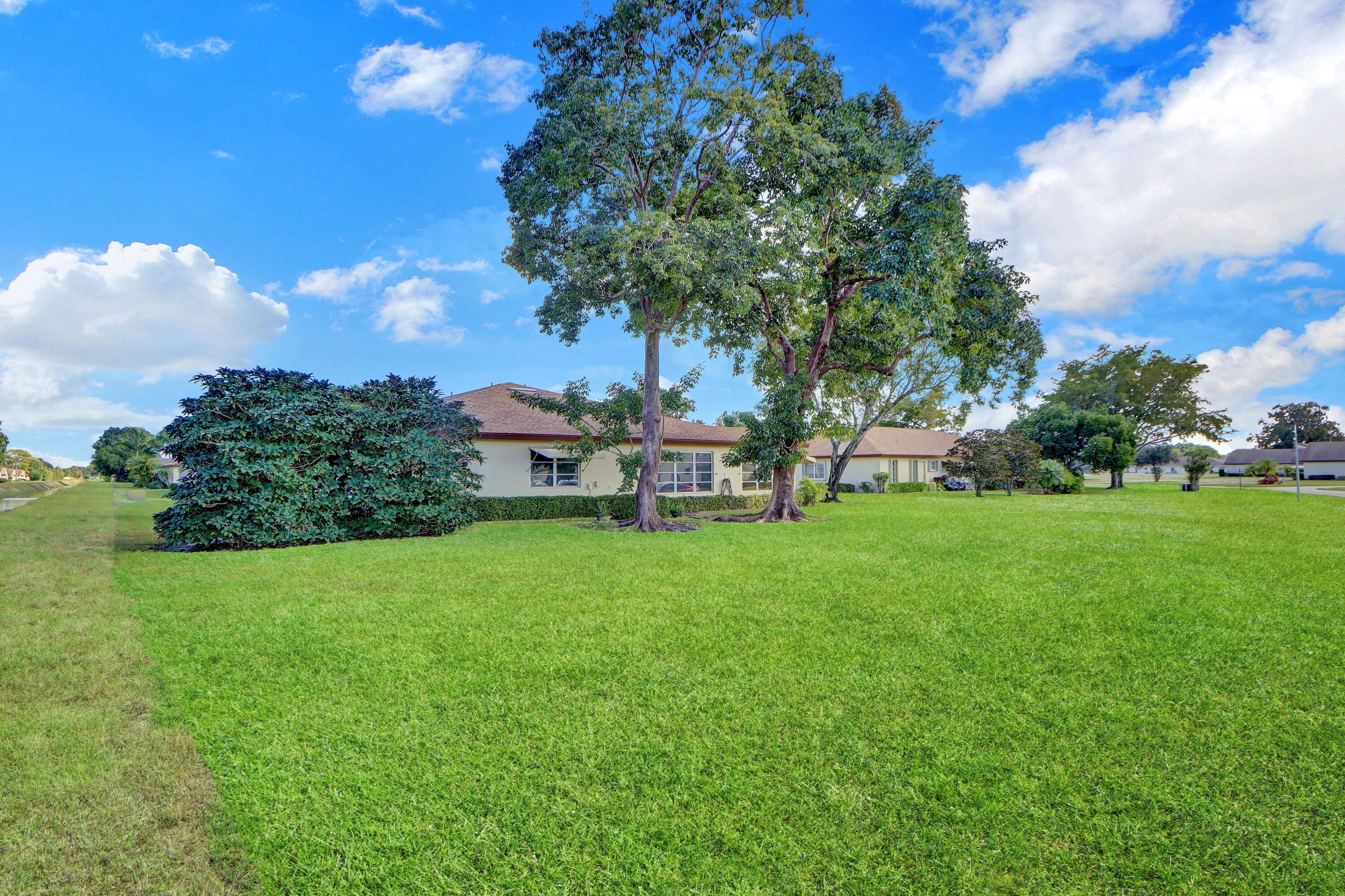 14050 Nesting Way, Unit B Delray Beach, FL 33484 - Photo 4 of 18 a view of a garden with houses