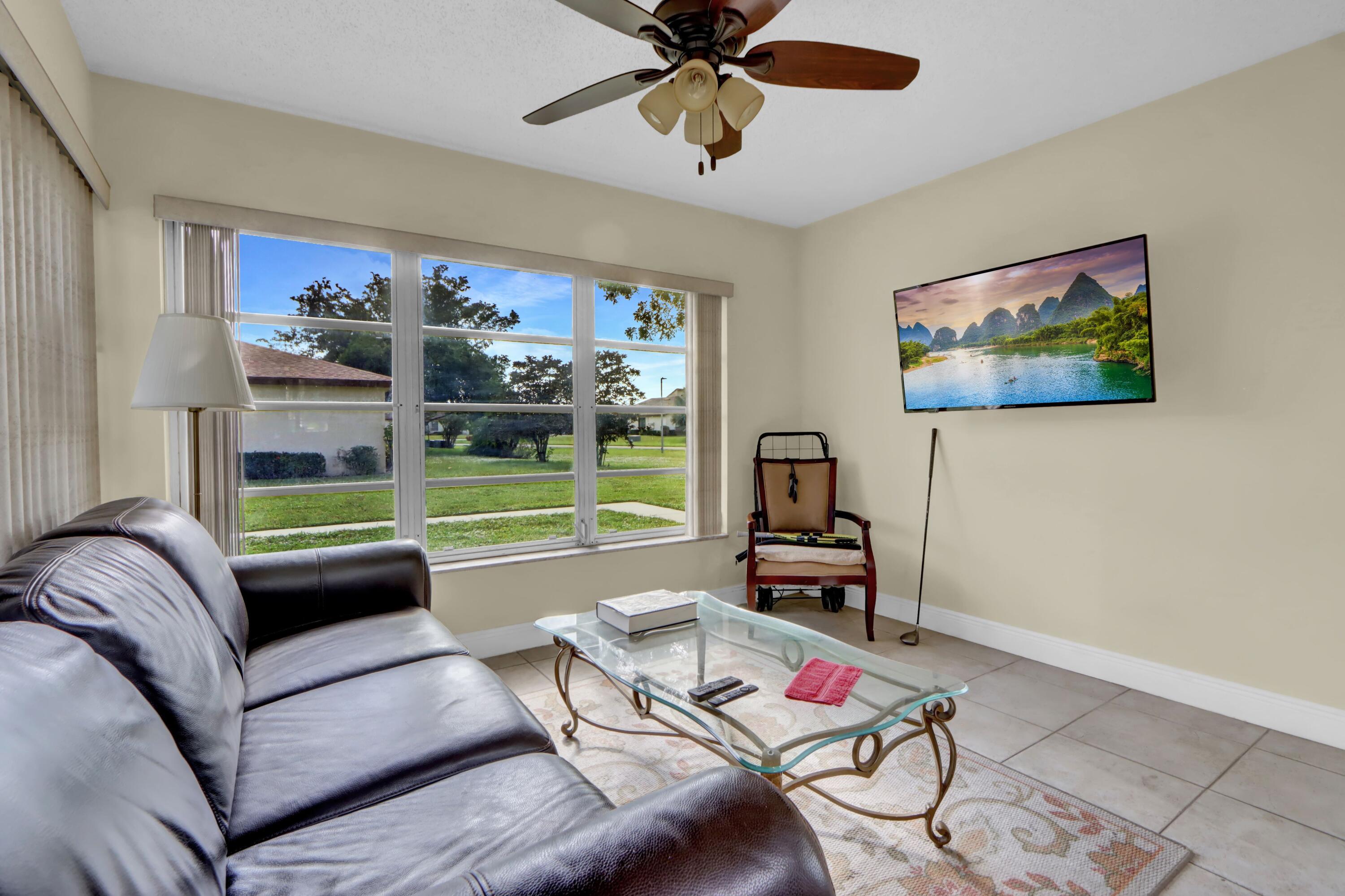 14050 Nesting Way, Unit B Delray Beach, FL 33484 - Photo 7 of 18 a living room with furniture and a flat screen tv