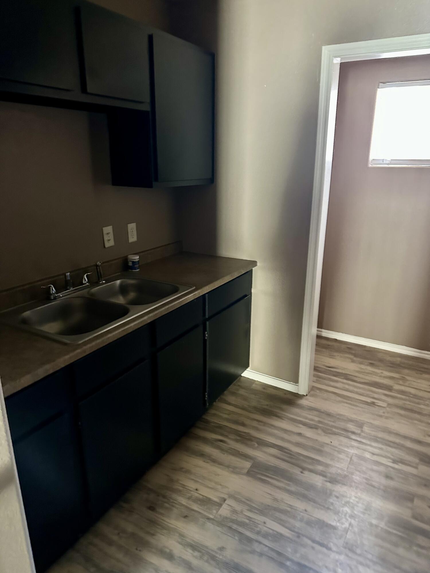 118 81st Street, Unit 1 Lubbock, TX 79404 - Photo 5 of 10 a kitchen with a sink and a stove