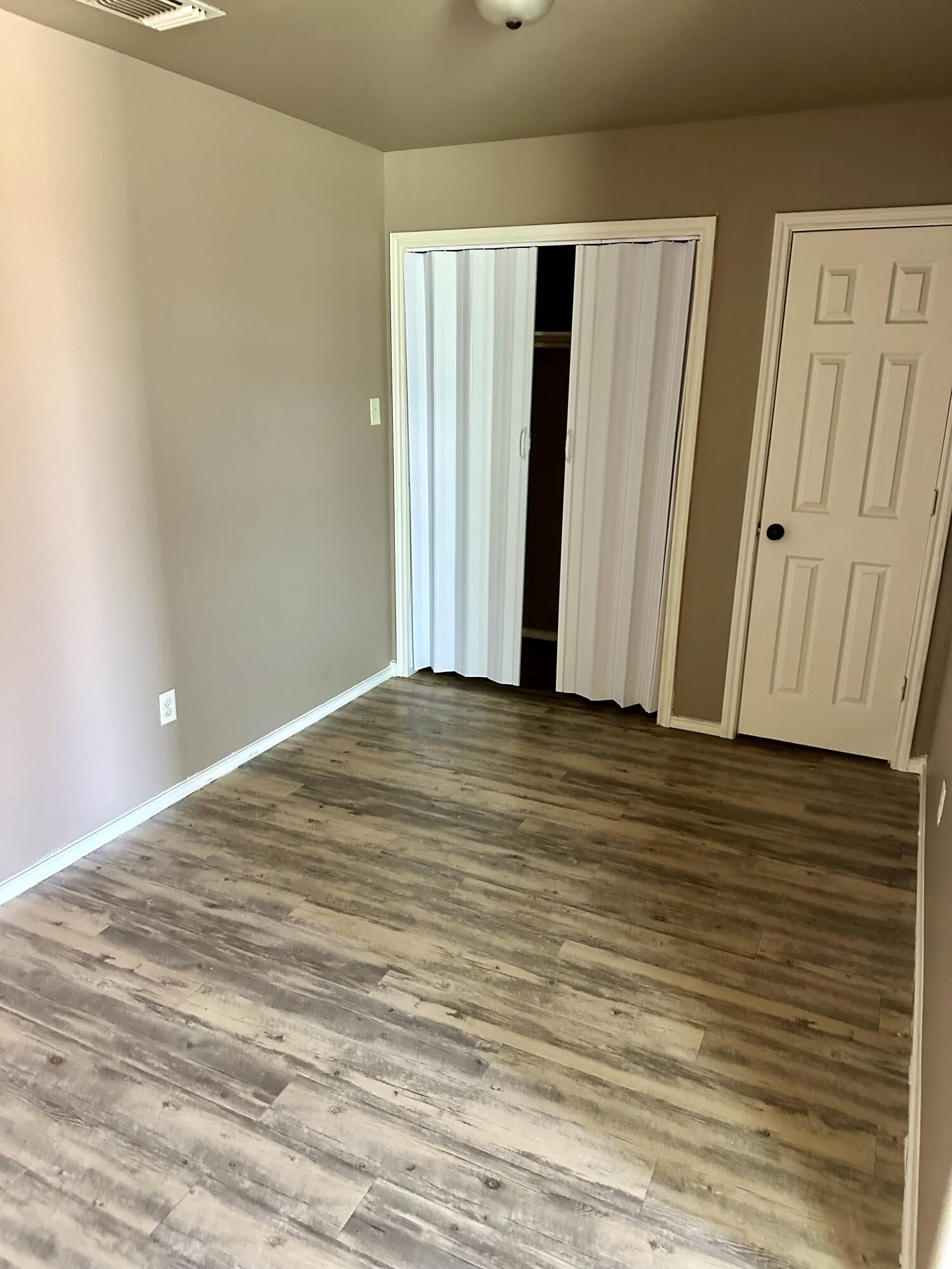 118 81st Street, Unit 1 Lubbock, TX 79404 - Photo 7 of 10 a view of wooden floor