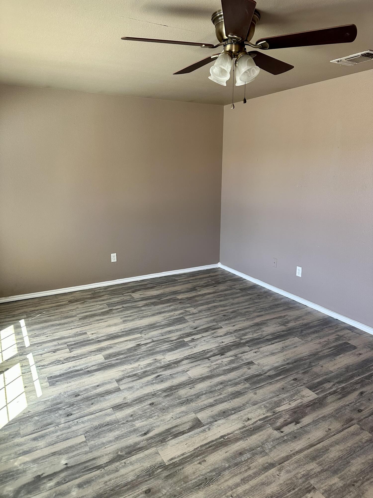 118 81st Street, Unit 1 Lubbock, TX 79404 - Photo 9 of 10 a view of a room with wooden floor and ceiling fan