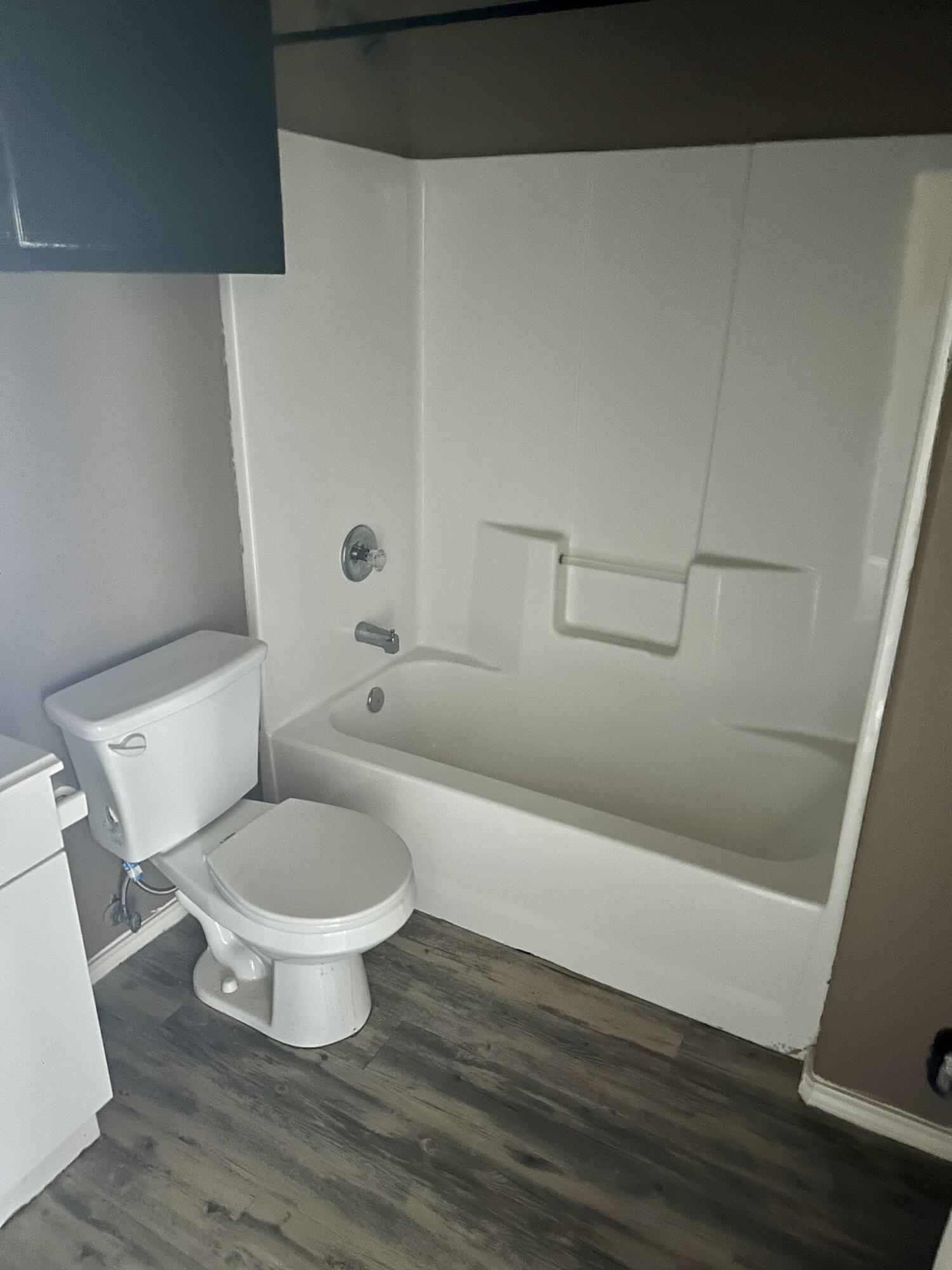 118 81st Street, Unit 1 Lubbock, TX 79404 - Photo 10 of 10 a white toilet sitting next to a bathroom sink