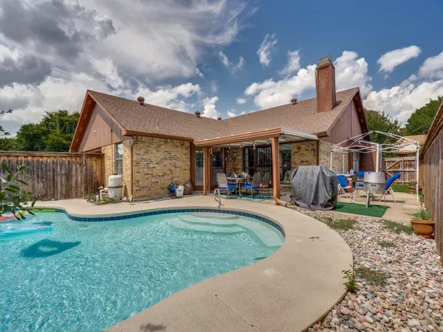 a view of a house with backyard sitting area and garden