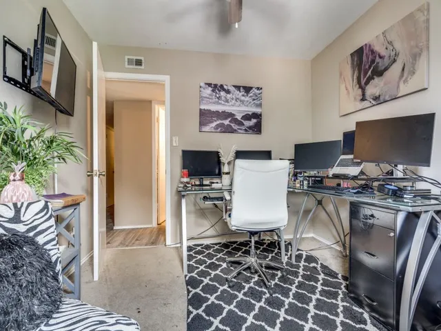 a living room with furniture and large windows