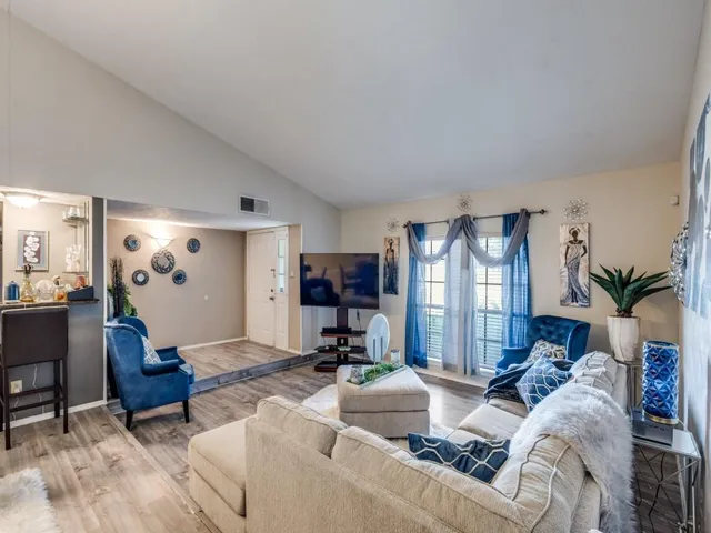a living room with furniture and a large window