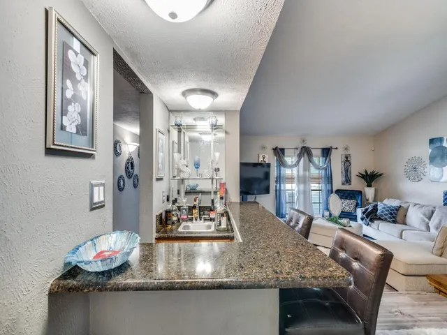 a view of a backyard with plants and outdoor seating