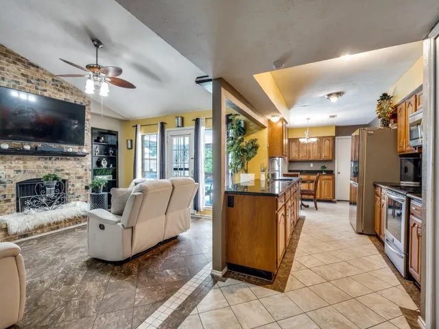 a living room with furniture a fireplace and a flat screen tv