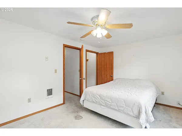 a bedroom with a large bed and a large window