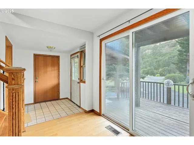 a living room with furniture and a dining table