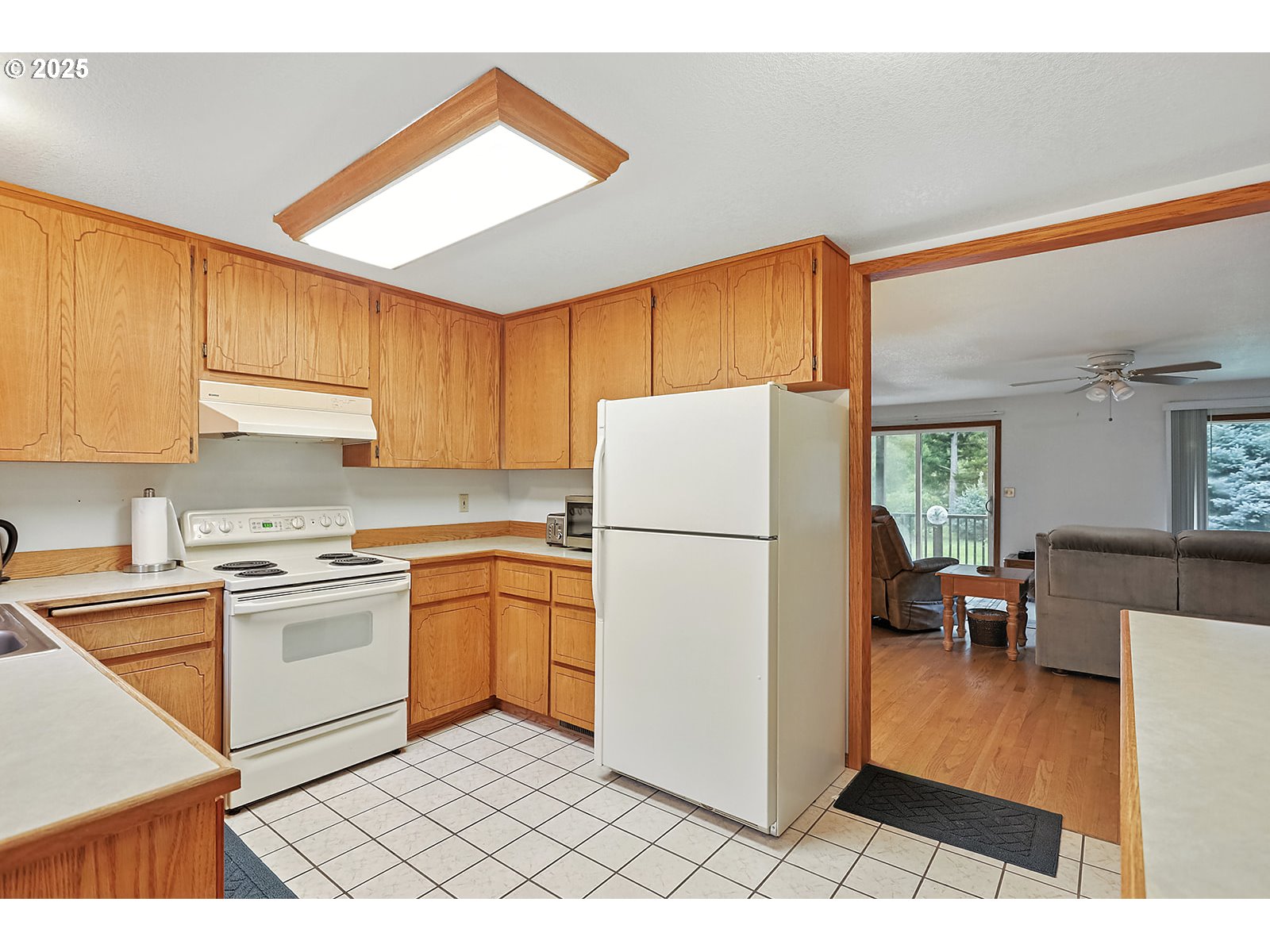 850 Highway 142 Lyle, WA 98635 - Photo 8 of 39 a kitchen with a refrigerator a stove a sink cabinets and a dining table