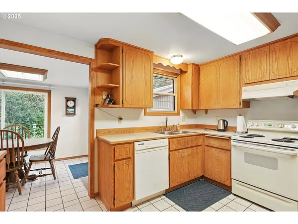 a view of a big room with wooden floor and windows