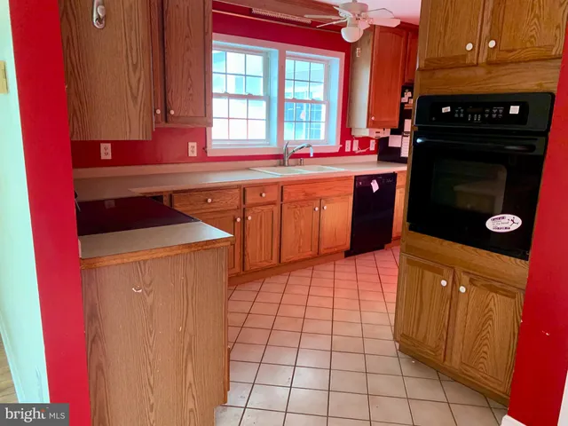 a kitchen with stainless steel appliances a stove a sink and a microwave