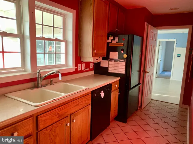 a view of a kitchen area with furniture and staircase