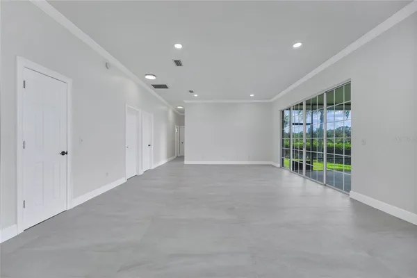 a kitchen with a refrigerator a sink and wooden floor