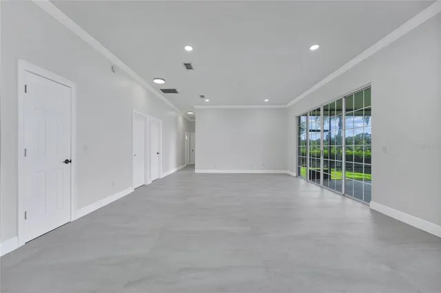 a kitchen with a refrigerator a sink and wooden floor