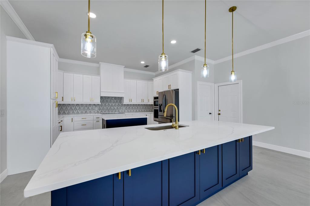 1703 Roberts Landing Road Windermere, FL 34786 - Photo 14 of 61 a kitchen with a refrigerator a sink and wooden floor