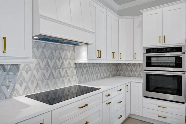 a kitchen with a refrigerator a sink and wooden floor