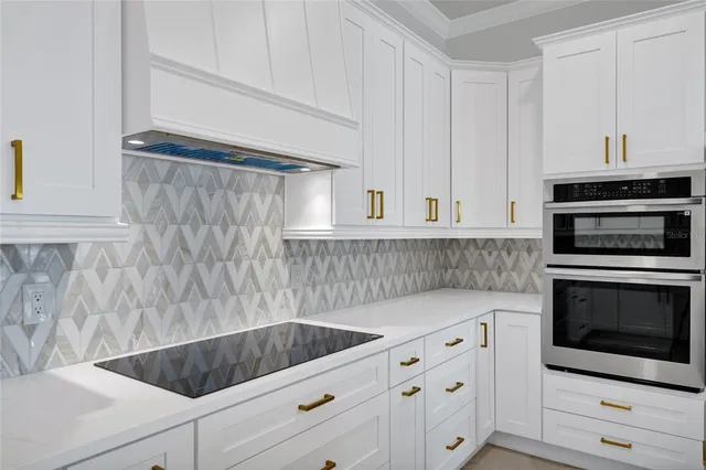 a kitchen with a refrigerator a sink and wooden floor