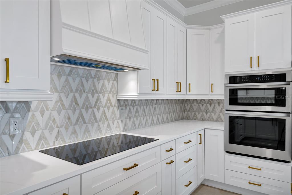 1703 Roberts Landing Road Windermere, FL 34786 - Photo 18 of 61 a kitchen with granite countertop white cabinets and stainless steel appliances