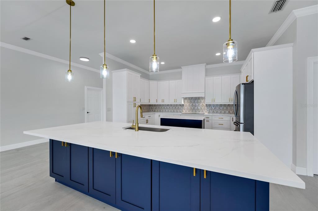 1703 Roberts Landing Road Windermere, FL 34786 - Photo 20 of 61 a kitchen with a refrigerator a sink and wooden floor