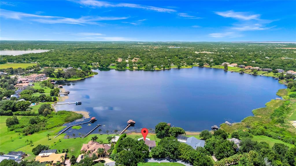 1703 Roberts Landing Road Windermere, FL 34786 - Photo 2 of 61 a view of a lake with a city